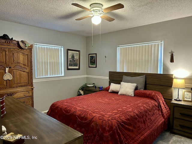 carpeted bedroom featuring a textured ceiling and ceiling fan