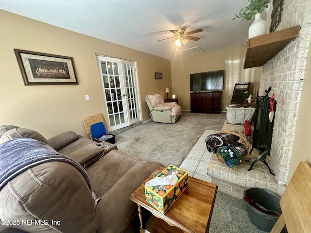 carpeted living area with a ceiling fan and french doors