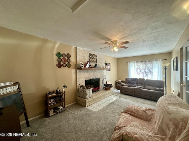 carpeted living room with baseboards, ceiling fan, and a brick fireplace