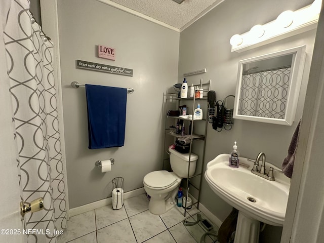 full bath featuring a sink, tile patterned floors, toilet, baseboards, and a textured ceiling