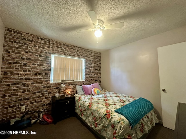 carpeted bedroom with a textured ceiling, a ceiling fan, and brick wall