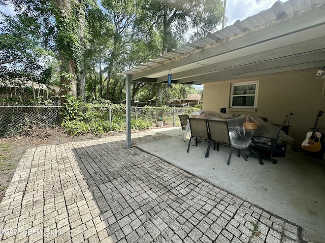 view of patio with outdoor dining area and a fenced backyard