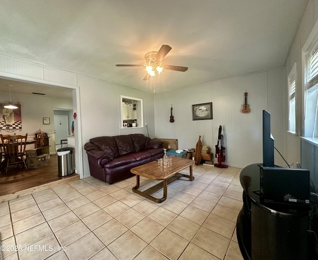 living room with light tile patterned floors and a ceiling fan