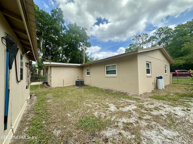 view of side of home with fence and cooling unit