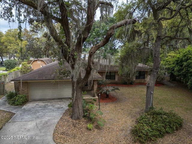 view of front of home with brick siding, a garage, and concrete driveway