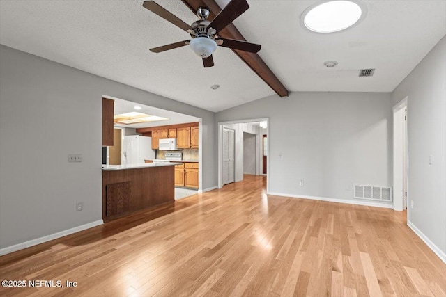 unfurnished living room with vaulted ceiling with beams, ceiling fan, light wood finished floors, and visible vents