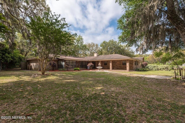 back of property with a yard and a chimney