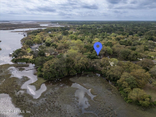 aerial view with a forest view and a water view