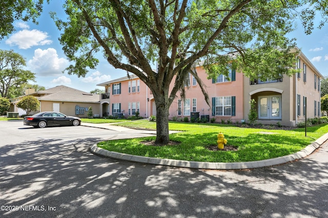 157 Jardin De Mer Pl Unit 157, Jacksonville Beach, FL 32250 - view of front of home featuring stucco siding, central air condition unit, french doors, and a front yard