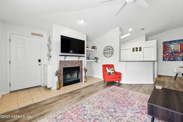 157 Jardin De Mer Pl Unit 157, Jacksonville Beach, FL 32250 - living room featuring a ceiling fan, vaulted ceiling, wood finished floors, and a fireplace