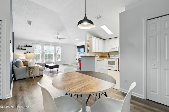 157 Jardin De Mer Pl Unit 157, Jacksonville Beach, FL 32250 - dining space featuring visible vents, ceiling fan, lofted ceiling, and wood finished floors