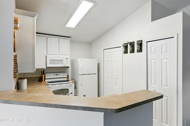 157 Jardin De Mer Pl Unit 157, Jacksonville Beach, FL 32250 - kitchen with white cabinets, a peninsula, vaulted ceiling, and white appliances