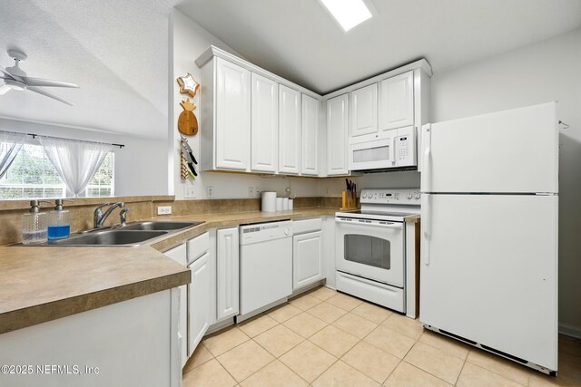157 Jardin De Mer Pl Unit 157, Jacksonville Beach, FL 32250 - kitchen featuring white appliances, light tile patterned flooring, white cabinets, and a sink