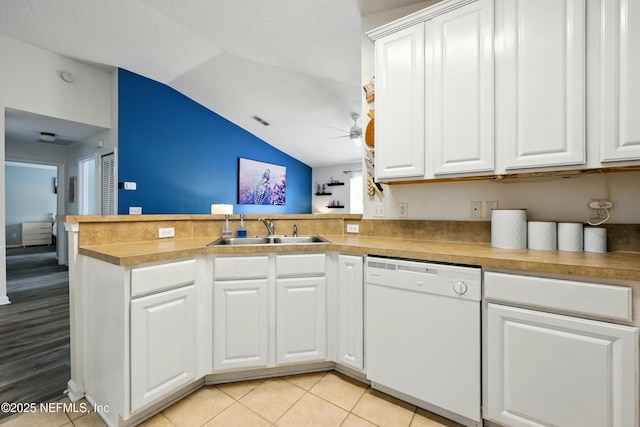 157 Jardin De Mer Pl Unit 157, Jacksonville Beach, FL 32250 - kitchen with white dishwasher, a sink, a ceiling fan, a peninsula, and vaulted ceiling