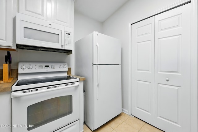 157 Jardin De Mer Pl Unit 157, Jacksonville Beach, FL 32250 - kitchen with light countertops, white cabinetry, light tile patterned floors, and white appliances