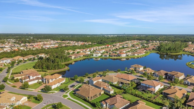 drone / aerial view with a residential view and a water view