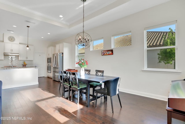 dining space featuring ornamental molding, recessed lighting, dark wood-style flooring, and a chandelier
