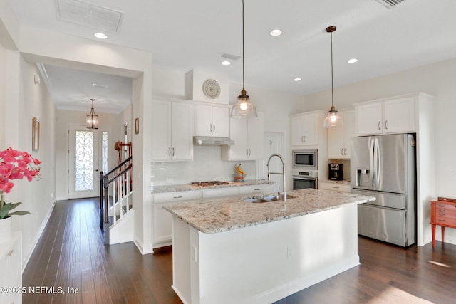 kitchen with appliances with stainless steel finishes, dark wood-style flooring, visible vents, and a sink
