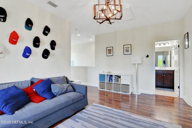 living area with visible vents, baseboards, an inviting chandelier, recessed lighting, and wood finished floors