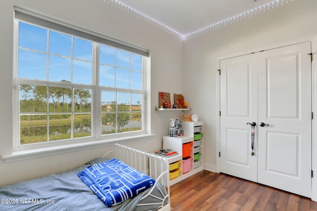 bedroom with dark wood-style flooring and baseboards
