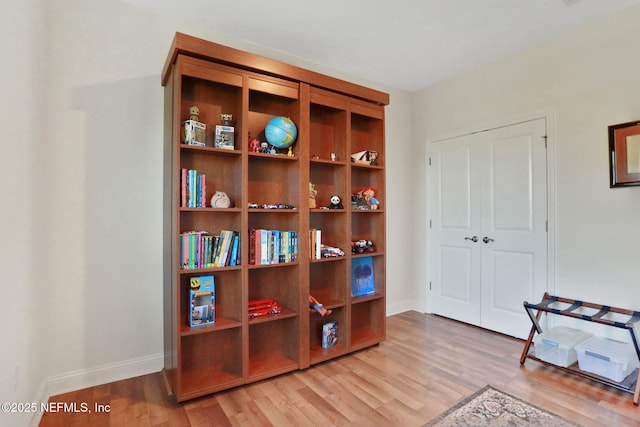 sitting room featuring baseboards and light wood-style floors