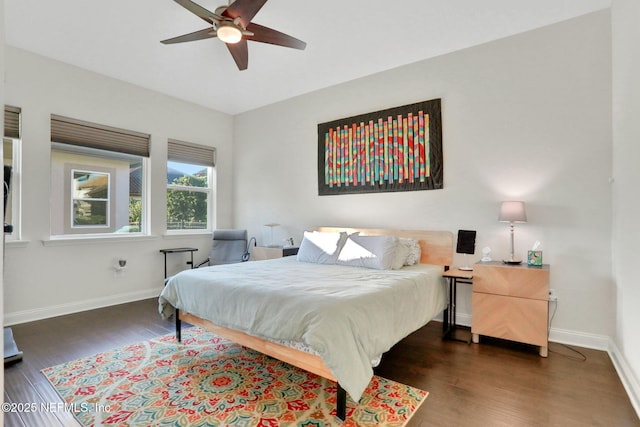 bedroom featuring ceiling fan, wood finished floors, and baseboards