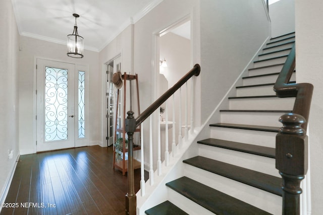 entryway with crown molding, stairs, wood finished floors, and baseboards