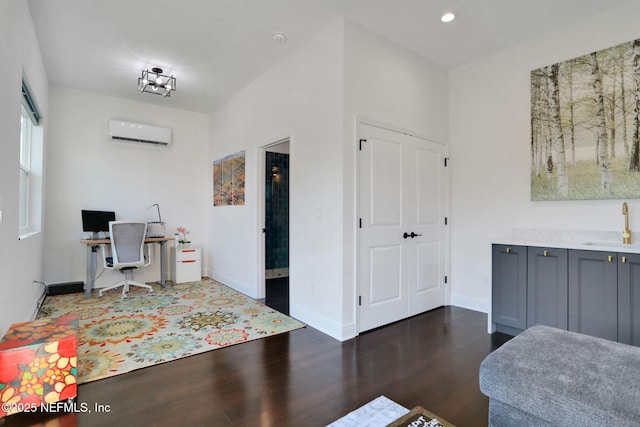office area with a sink, baseboards, dark wood-style flooring, recessed lighting, and a wall mounted air conditioner