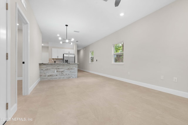7708 Galveston Ave, Jacksonville, FL 32211 - unfurnished living room featuring baseboards, recessed lighting, and ceiling fan with notable chandelier