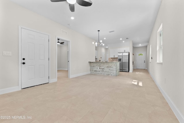 7708 Galveston Ave, Jacksonville, FL 32211 - unfurnished living room featuring baseboards, visible vents, ceiling fan with notable chandelier, and recessed lighting