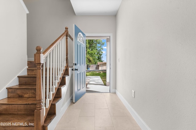 7708 Galveston Ave, Jacksonville, FL 32211 - foyer entrance with light tile patterned floors, stairway, and baseboards