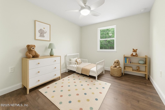 7708 Galveston Ave, Jacksonville, FL 32211 - bedroom featuring a crib, ceiling fan, baseboards, and dark wood finished floors