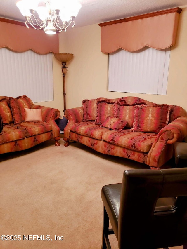living area with an inviting chandelier and carpet floors