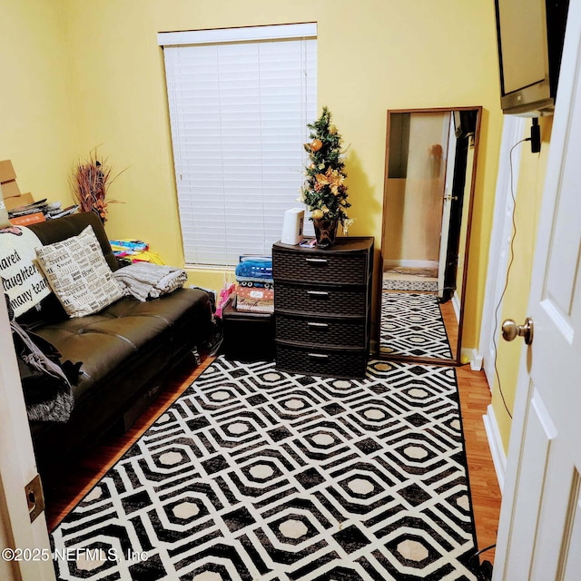 living area with light wood finished floors and baseboards