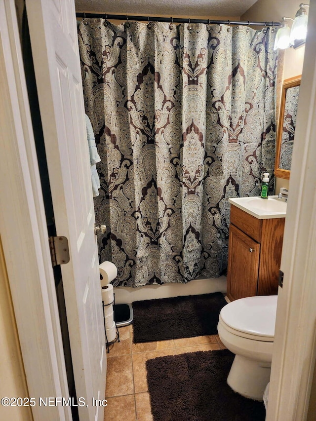 full bathroom with toilet, vanity, curtained shower, and tile patterned floors