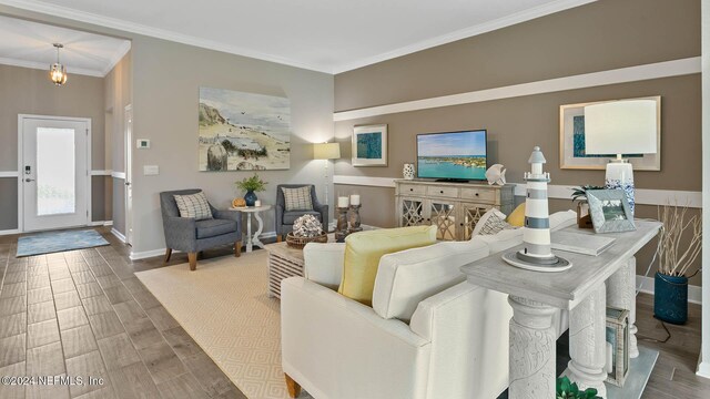 living room featuring baseboards, ornamental molding, and wood finished floors