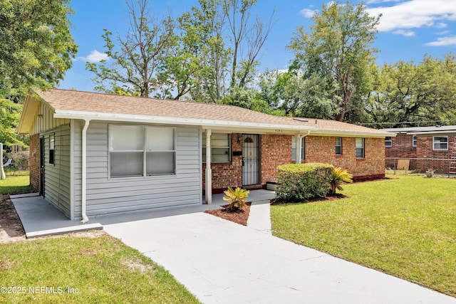 4043 Marland St, Jacksonville, FL 32209 - single story home with fence, roof with shingles, brick siding, and a front lawn