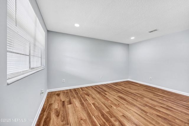 4043 Marland St, Jacksonville, FL 32209 - unfurnished room featuring recessed lighting, wood finished floors, baseboards, visible vents, and a textured ceiling