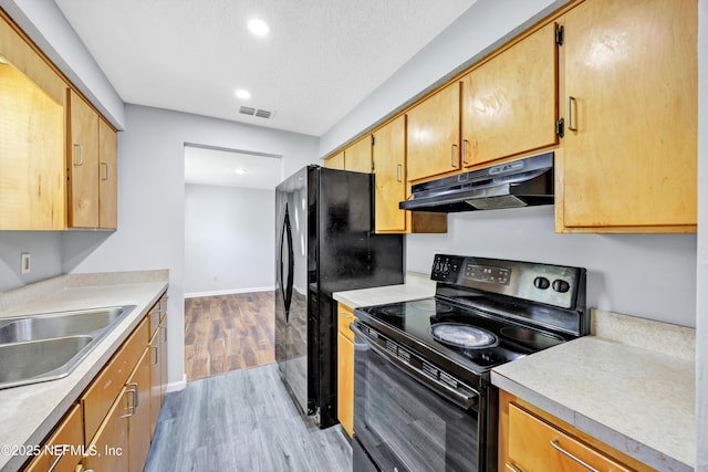 4043 Marland St, Jacksonville, FL 32209 - kitchen with recessed lighting, a sink, under cabinet range hood, black appliances, and light wood-style flooring