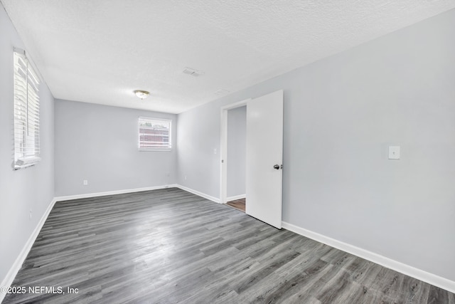 4043 Marland St, Jacksonville, FL 32209 - empty room featuring a textured ceiling, wood finished floors, and baseboards
