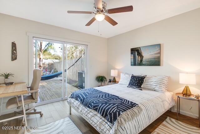 bedroom with access to exterior and wood finished floors
