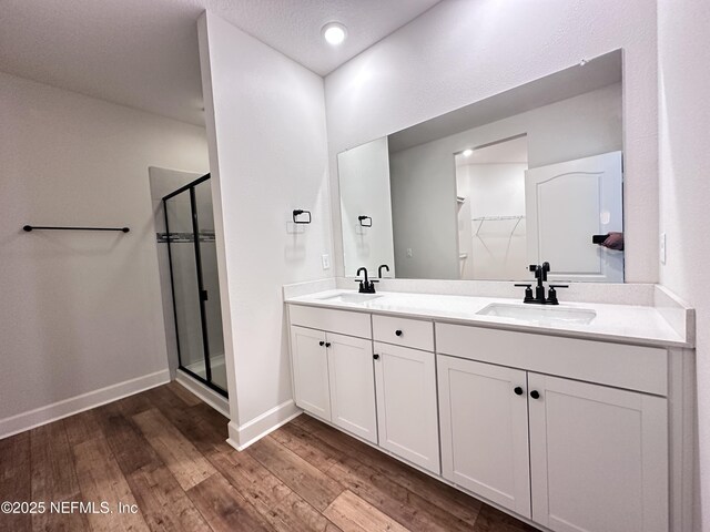 1116 Morgans Treasure Rd, Saint Augustine, FL 32084 - full bathroom featuring a sink, baseboards, a stall shower, and wood finished floors