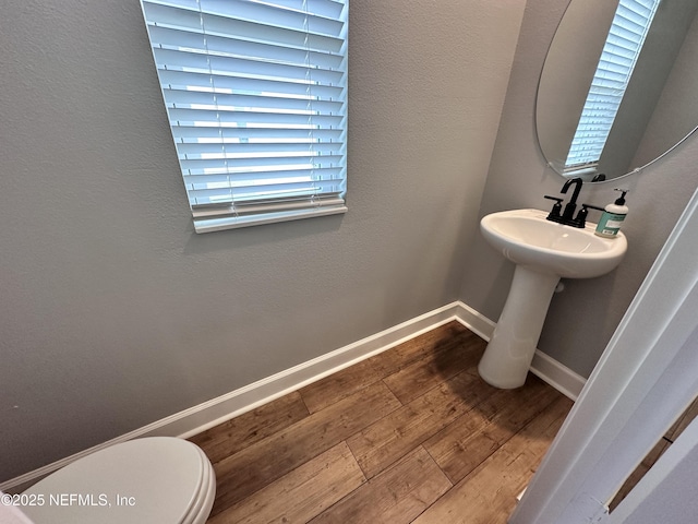 1116 Morgans Treasure Rd, Saint Augustine, FL 32084 - half bathroom featuring baseboards, toilet, and hardwood / wood-style floors