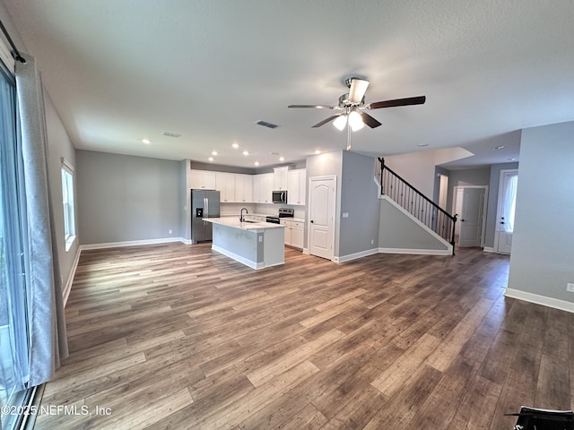 1116 Morgans Treasure Rd, Saint Augustine, FL 32084 - unfurnished living room with baseboards, a ceiling fan, stairs, and wood finished floors