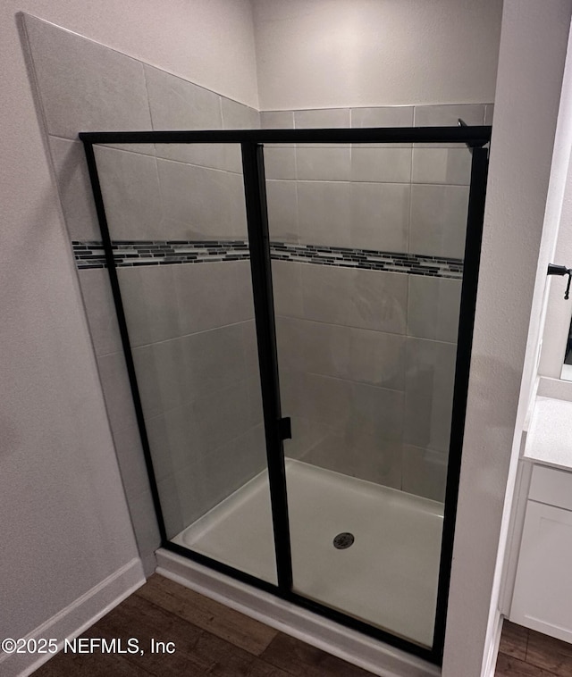 1116 Morgans Treasure Rd, Saint Augustine, FL 32084 - full bathroom with wood finished floors, baseboards, and a stall shower