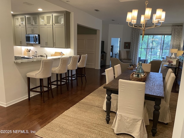 1207 Makarios Dr, Saint Augustine Beach, FL 32080 - dining room featuring dark wood-style flooring, a chandelier, and recessed lighting
