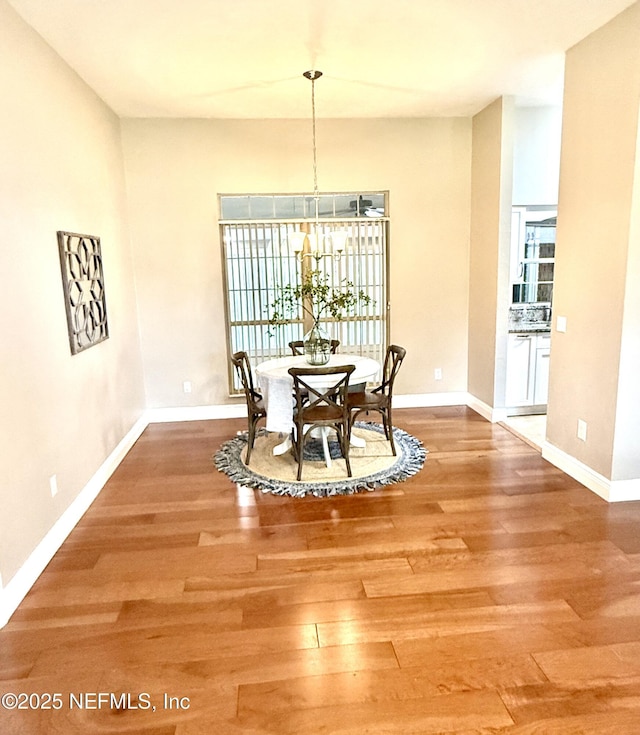 dining area featuring wood finished floors and baseboards