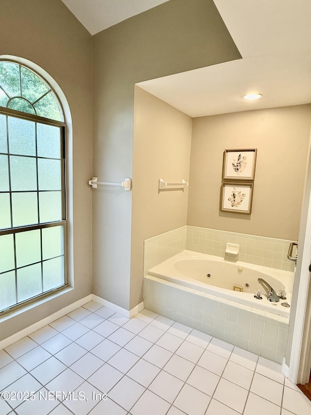 full bath featuring a tub with jets, tile patterned floors, and baseboards