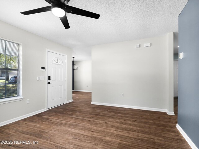 1615 Brook Forest Dr, Jacksonville, FL 32208 - interior space featuring dark wood-style flooring, ceiling fan, baseboards, and a textured ceiling