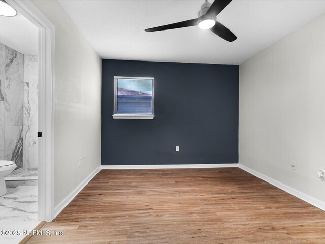 1615 Brook Forest Dr, Jacksonville, FL 32208 - interior space with baseboards, wood finished floors, a ceiling fan, and ensuite bathroom